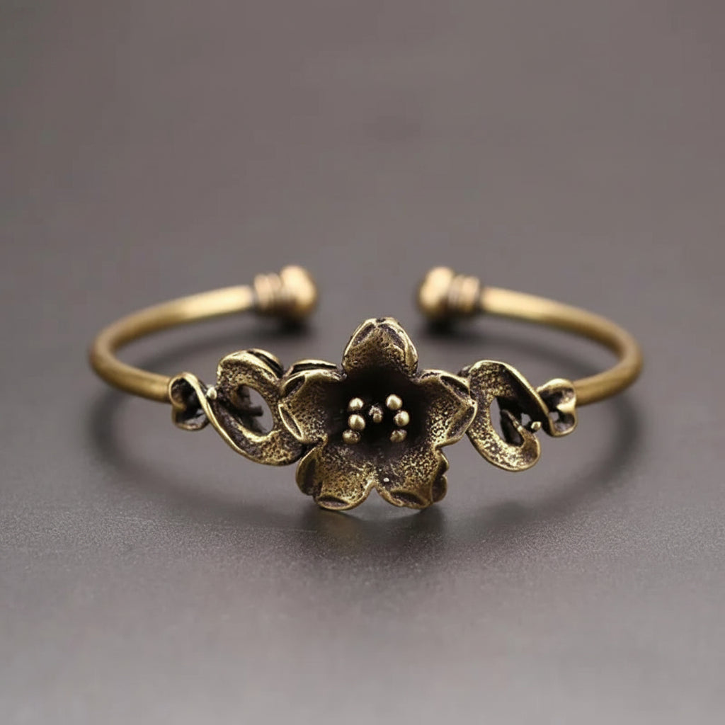 Bronze floral bracelet on a gray background
