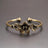 Bronze floral bracelet on a gray background