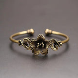 Bronze floral bracelet on a gray background