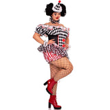 A woman modeling a jester costume against a plain white background. The costume includes a black-and-white harlequin patterned top with red trim, a black-and-white checkered hat with a red pom-pom, a red-and-white striped skirt, fishnet stockings, and red high-heeled boots.