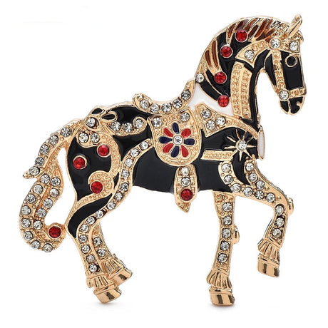 Decorative horse brooch with gold, black, and red details on a white background