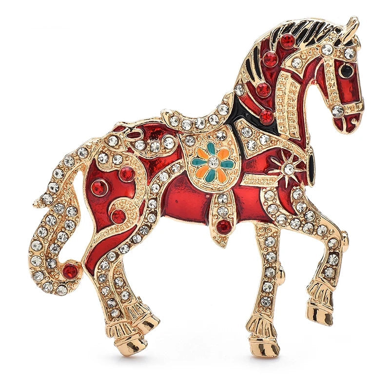 Decorative horse brooch with red, gold, and black colors on a white background